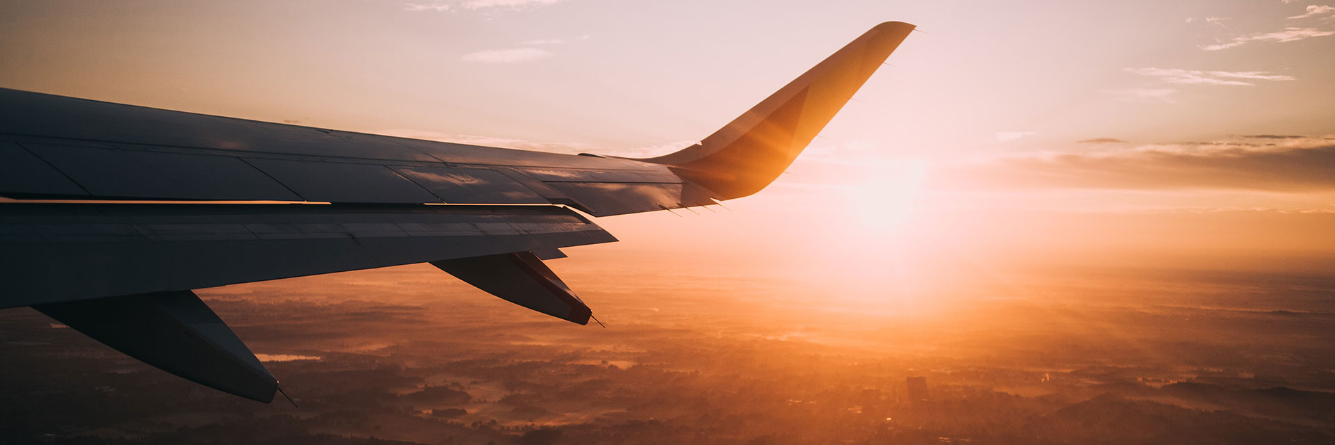 Airplane in the sky during golden hour.